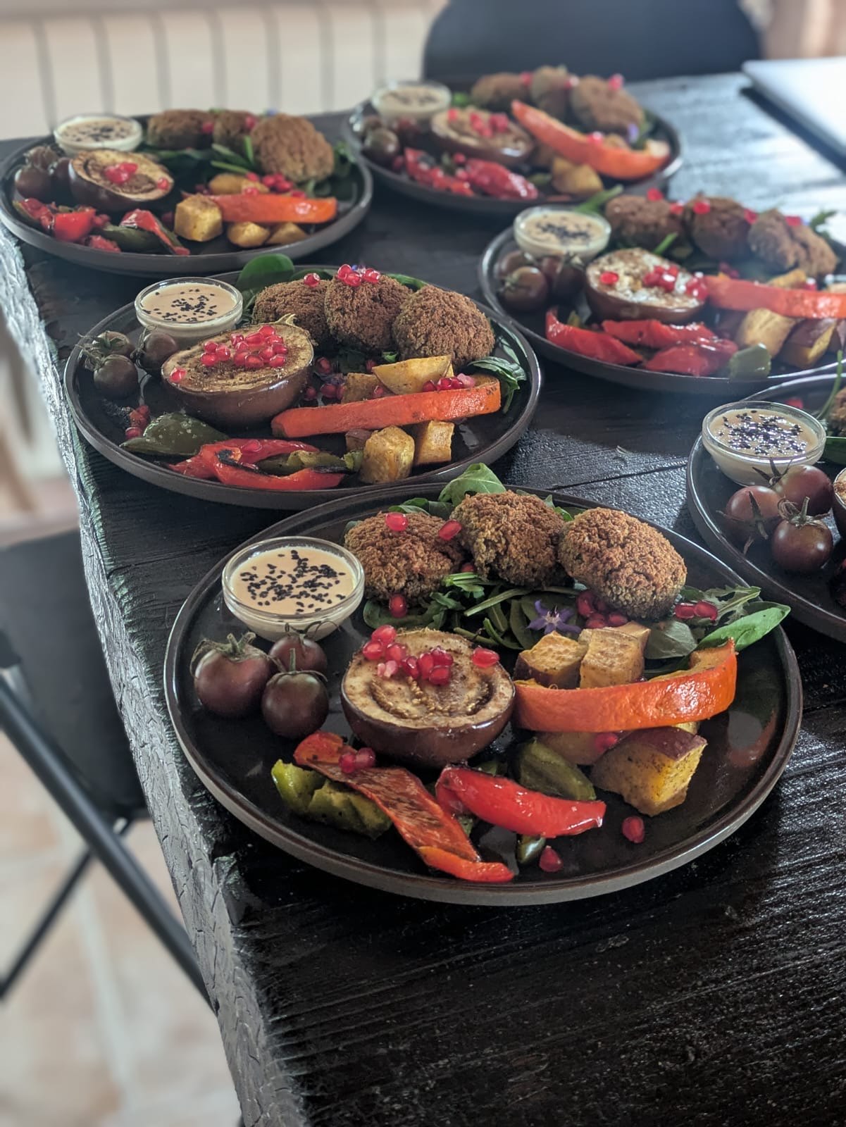 Plates of falafel and roasted vegetables ready to serve