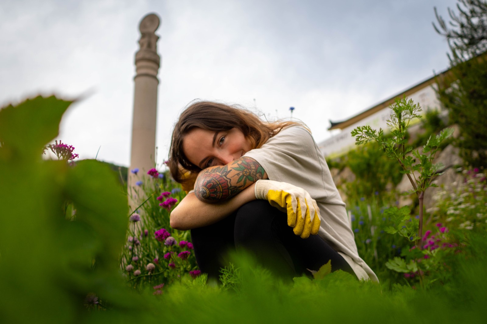Lindsay crouched among wildflowers in the garden