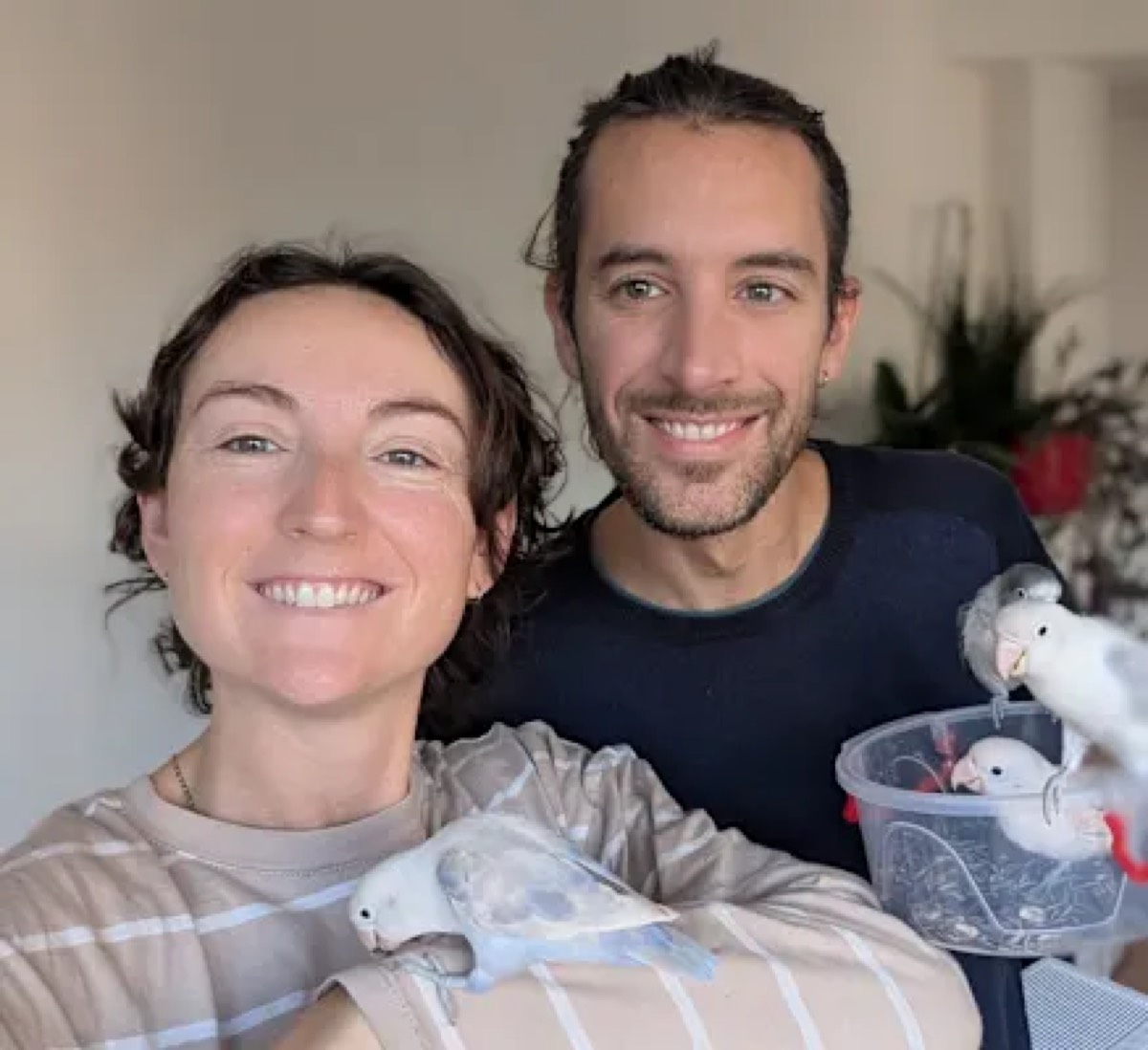 Lindsay and Chris holding two cockatiels